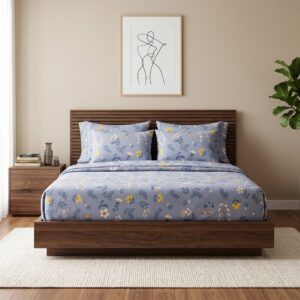 Dusty blue floral print cotton bedsheet set on wooden bed with matching pillow covers